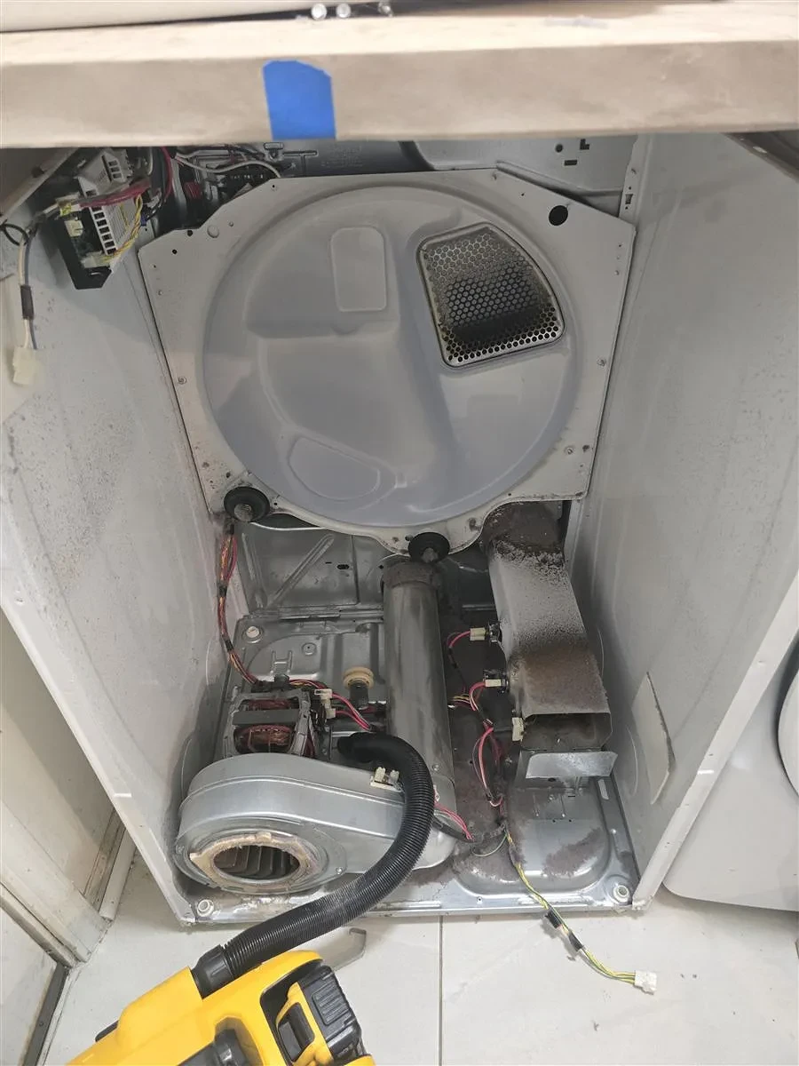 Vacuuming inside the Samsung dryer during repair