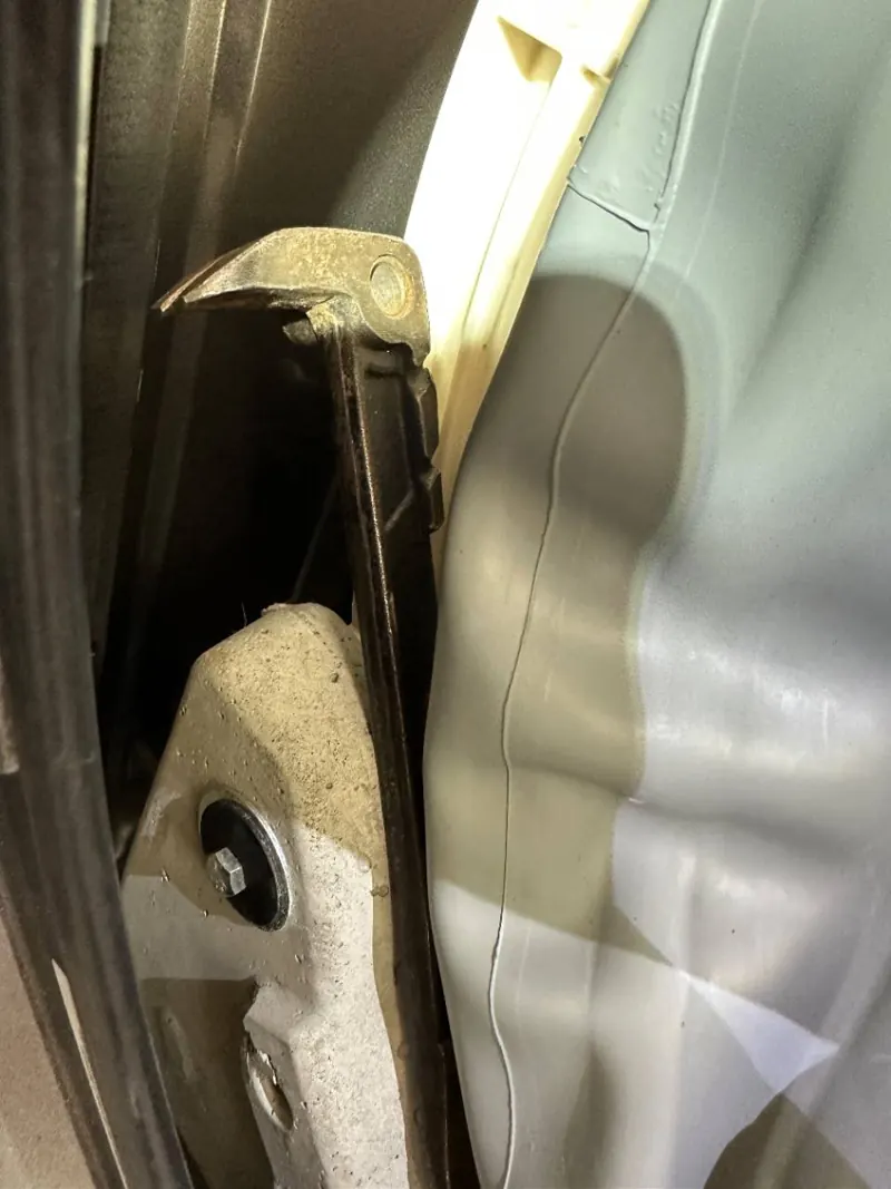 Metal tool visible inside the Electrolux washer near the front of the tub